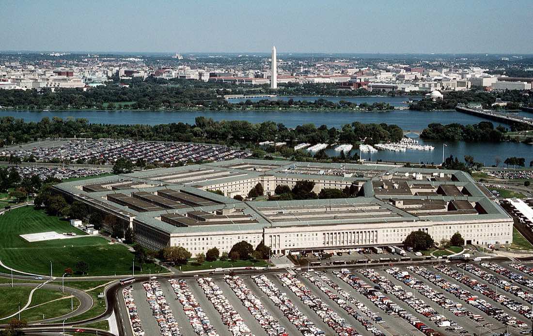 Fotografia aérea do prédio pentagonal do Departamento de Defesa dos Estados Unidos, com o rio Potomac ao fundo.